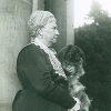 Mrs Ropner holding her dog small dog on her lap in 1882.