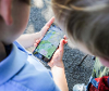 Two kids looking at mobile phone on the love exploring app