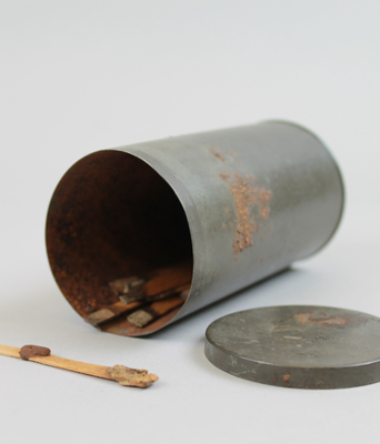 Silver tin with John Walkers match.