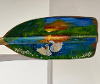 Painted artwork of swans on the end of rowing paddle.