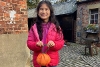 Child making a paper pumpkin at Preston Park Museum