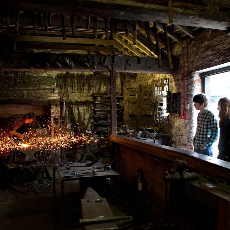 Blacksmith In The Forge On The Victorian Street Blacksmith at work on the Victorian Street