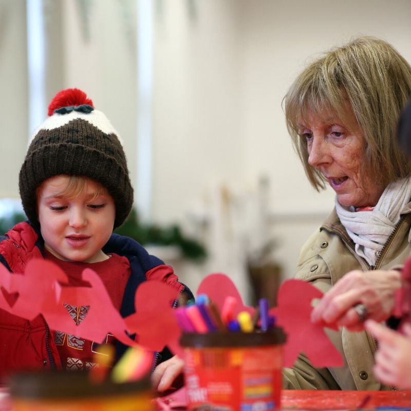 Child And Grandparent Making Christmas Craft Child And Grandparent Making Christmas Craft