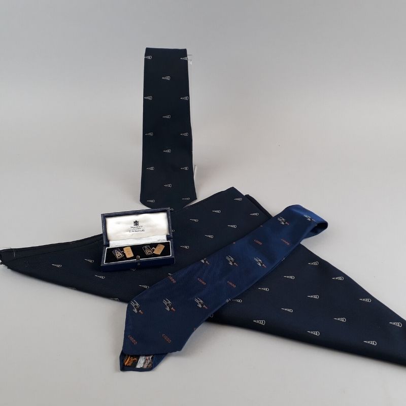 the items that Jean was given when she joined the 1000 Mph Club. There are two ties, a scarf and a set of cufflinks. They all include the club logo and the cufflinks are also inscribed with Jean’s initials - JEO.